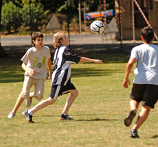 Students playing football during summer English course
